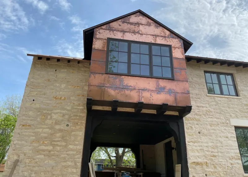 Copper metal panel facade on a stone building for Roof Repair in Kingstowne